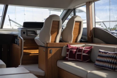 Interior of a luxury yacht with sleek seating and stylish cushions.