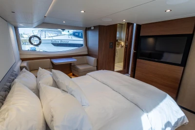 Interior of a luxurious cabin with a double bed and large window.