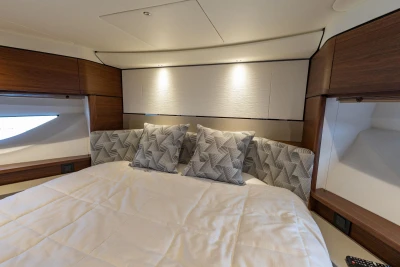Luxurious bedroom with modern design and elegant pillows on a large bed.