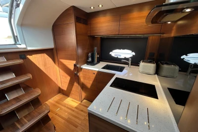 Luxurious kitchen interior of 2017 Princess V48 Open yacht with modern appliances and wood finish.
