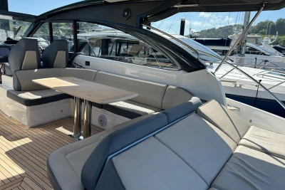 Luxurious 2017 Princess V48 Open yacht interior with elegant seating and wooden table.