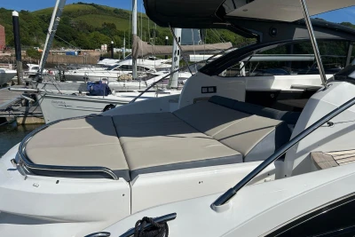 2017 Princess V48 Open yacht with sunbed, docked at marina.
