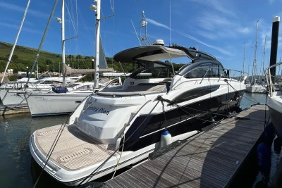 2017 Princess V48 Open yacht docked at marina under clear blue sky.