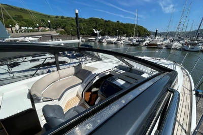 2017 Princess V48 Open yacht with sleek design, docked in a scenic marina.