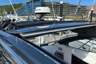 2017 Princess V48 Open yacht with open sunroof at marina.