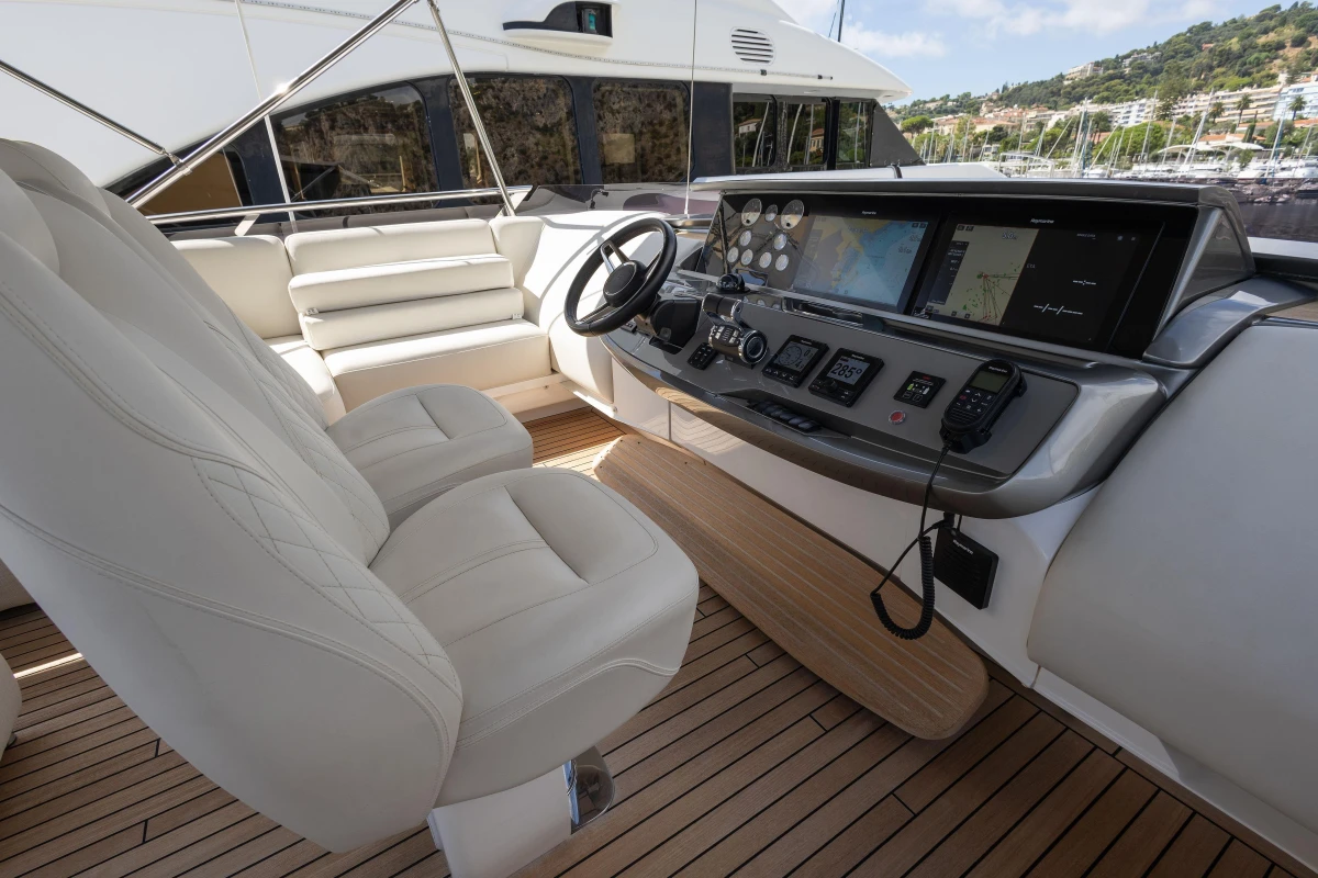 Luxurious 2022 Princess S78 yacht helm with modern navigation systems and plush seating.