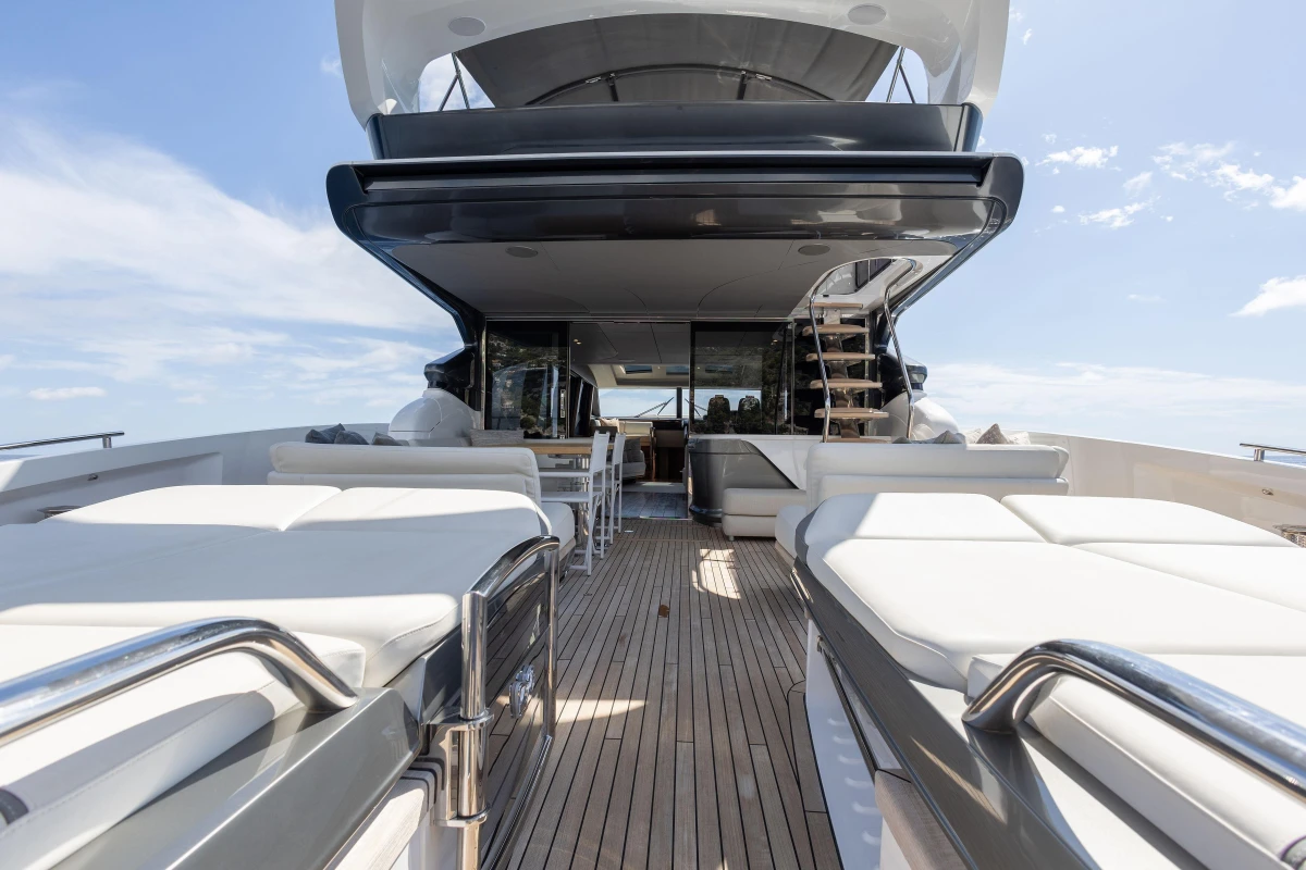 Luxurious 2022 Princess S78 yacht deck with sun loungers and elegant seating area.