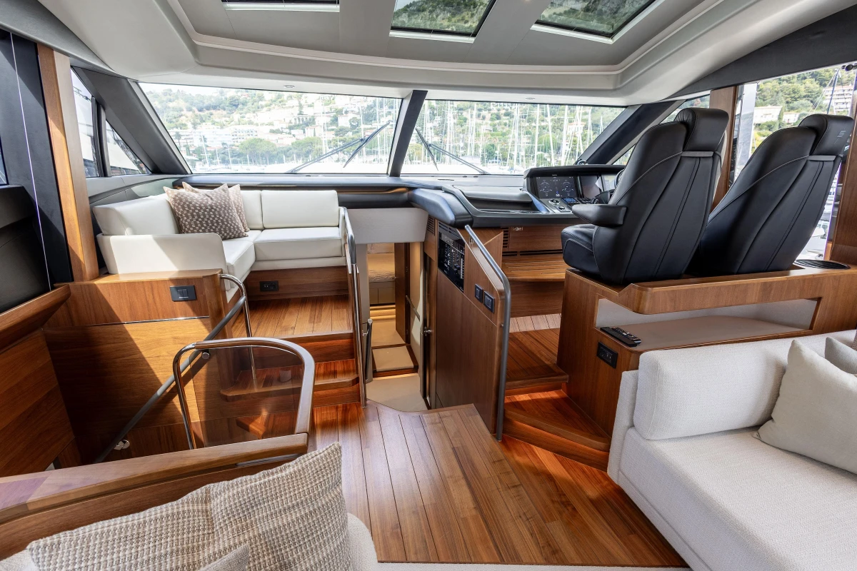 Luxurious interior of 2022 Princess S78 yacht with elegant seating and modern helm.