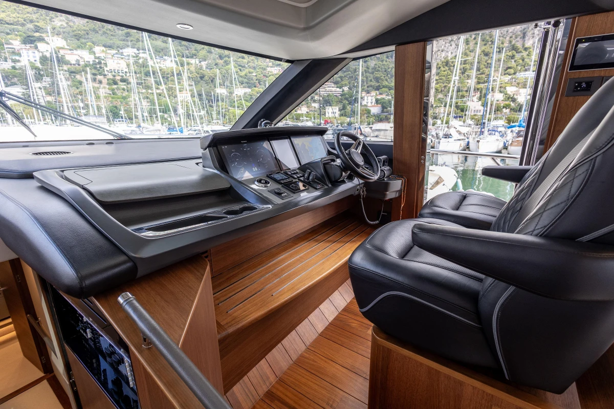 Luxurious 2022 Princess S78 yacht helm with leather seating and advanced navigation controls.