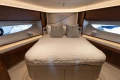 Luxurious bedroom interior of 2022 Princess S78 yacht with elegant wood finishes.