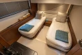 Luxurious 2022 Princess S78 yacht cabin with twin beds and elegant decor.