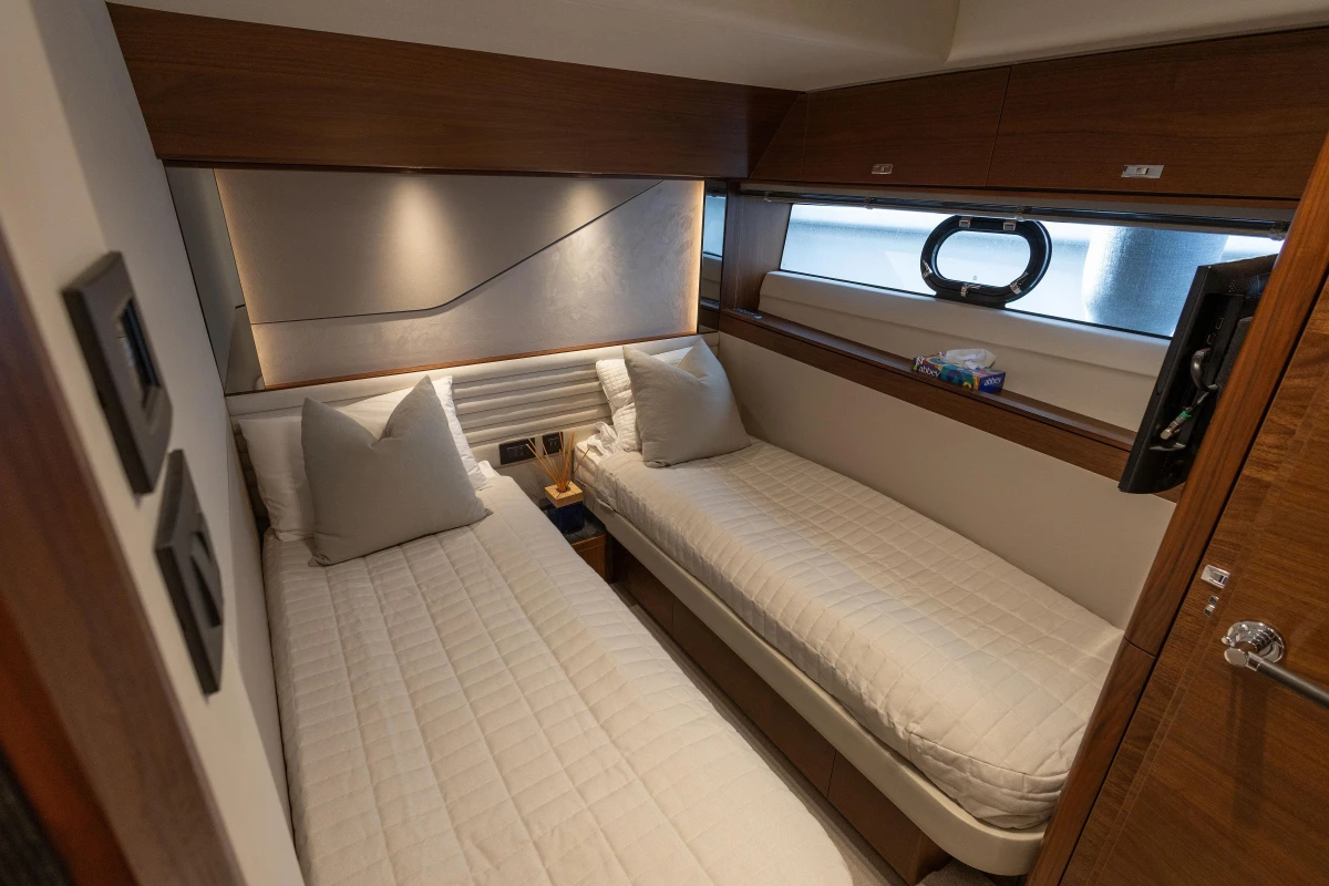 Luxurious twin cabin interior on 2022 Princess S78 yacht, featuring elegant wood finishes.