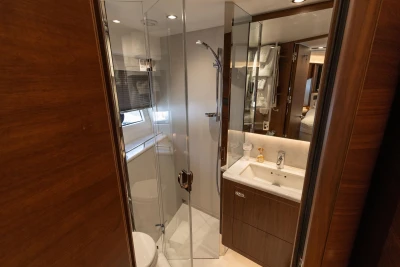 Luxurious bathroom in 2022 Princess S78 yacht with modern fixtures and elegant wood finishes.