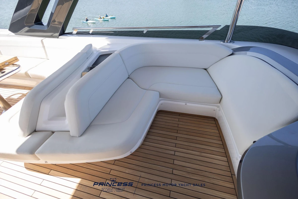 Luxurious seating area on 2023 Princess S72 yacht with elegant wooden deck.