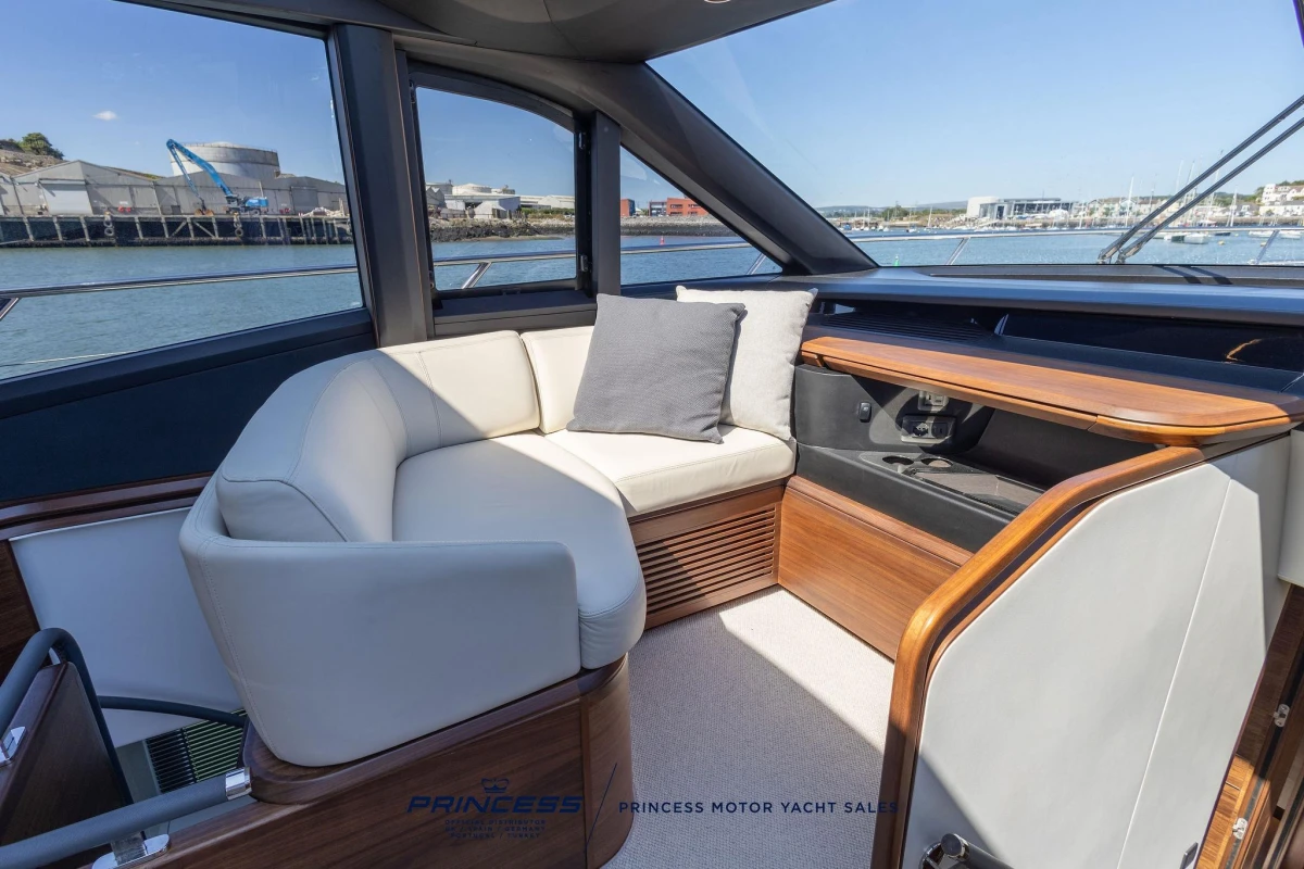 Luxurious interior of 2023 Princess S72 yacht with elegant seating and wooden accents.