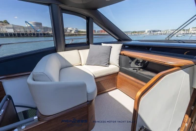 Luxurious interior of 2023 Princess S72 yacht with elegant seating and wooden accents.