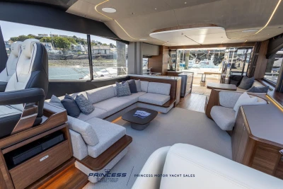 Luxurious interior of 2023 Princess S72 yacht with modern seating and panoramic windows.