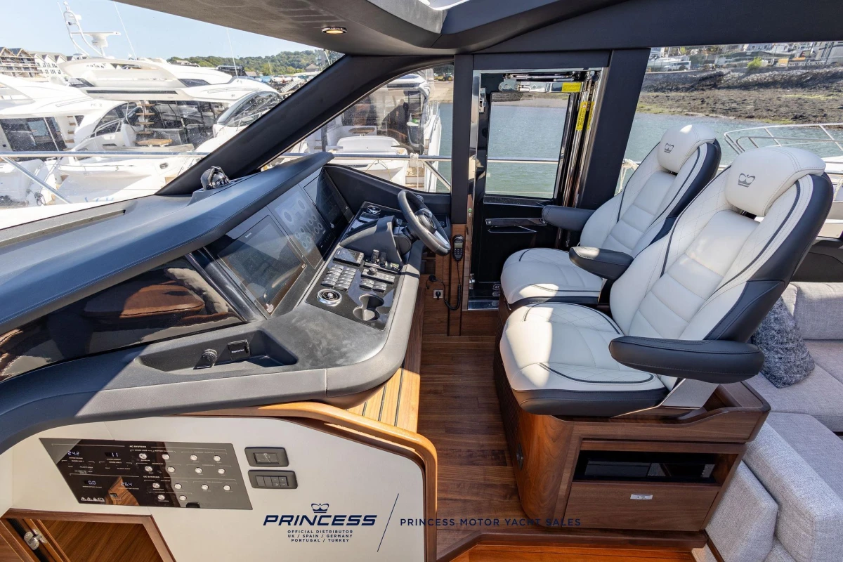 Luxurious 2023 Princess S72 yacht cockpit with modern controls and plush seating.