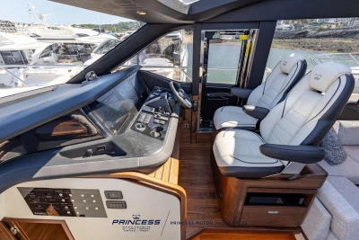 Luxurious 2023 Princess S72 yacht cockpit with modern controls and plush seating.