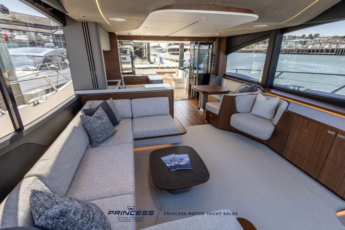 Luxurious interior of 2023 Princess S72 yacht with elegant seating and waterfront view.