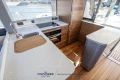 Modern kitchen interior of 2023 Princess S72 yacht with sleek wood and white finishes.