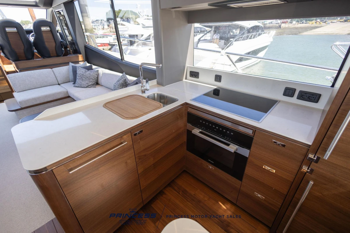 Luxurious kitchen interior of 2023 Princess S72 yacht with modern appliances and sleek design.