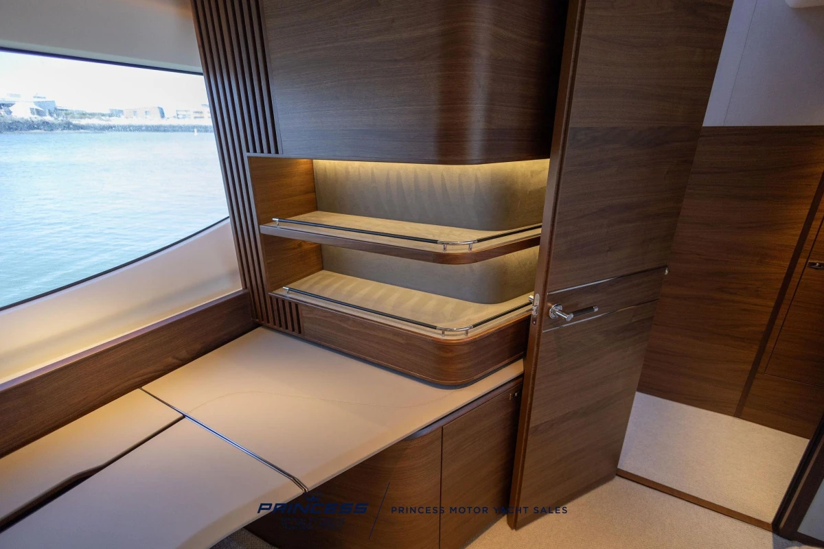 Luxurious interior of 2023 Princess S72 yacht with elegant wood finishes and ocean view.