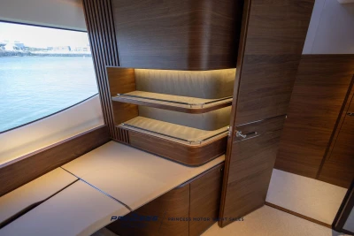 Luxurious interior of 2023 Princess S72 yacht with elegant wood finishes and ocean view.