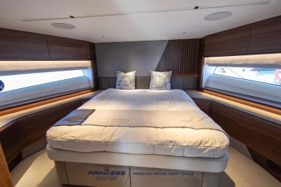 Luxurious 2023 Princess S72 yacht bedroom with elegant design and panoramic windows.