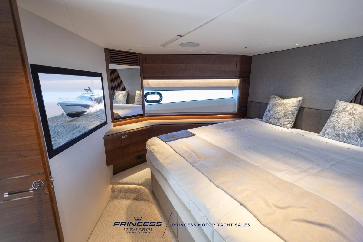 Luxurious bedroom interior of 2023 Princess S72 yacht with elegant bedding and modern decor.
