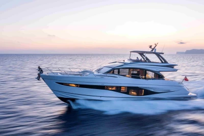 2023 Princess S72 yacht cruising at sunset on open water.
