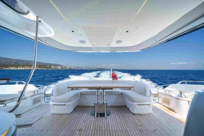 Luxurious 2023 Princess S72 yacht cruising on open sea with elegant deck seating.