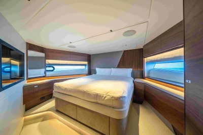 Luxurious bedroom interior of 2023 Princess S72 yacht, featuring modern design and ambient lighting.