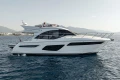 2019 Princess F50 yacht cruising on calm waters with scenic mountain backdrop.