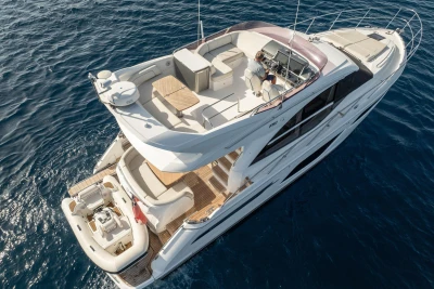 Luxurious 2019 Princess F50 yacht cruising on open sea, top view.