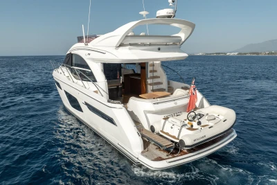 Luxury 2019 Princess F50 yacht cruising on open sea with tender boat.