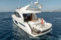 Luxury 2019 Princess F50 yacht cruising on open sea with tender boat.