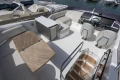 Luxurious 2019 Princess F50 yacht interior with seating, helm, and wooden table.