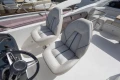 Luxury seating on 2019 Princess F50 yacht with modern steering wheel.