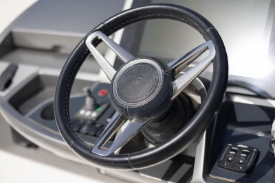 Steering wheel of a 2019 Princess F50 yacht, featuring modern controls and sleek design.
