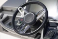 Steering wheel of a 2019 Princess F50 yacht, featuring modern controls and sleek design.