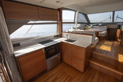 Luxurious 2019 Princess F50 yacht interior with modern kitchen and dining area.