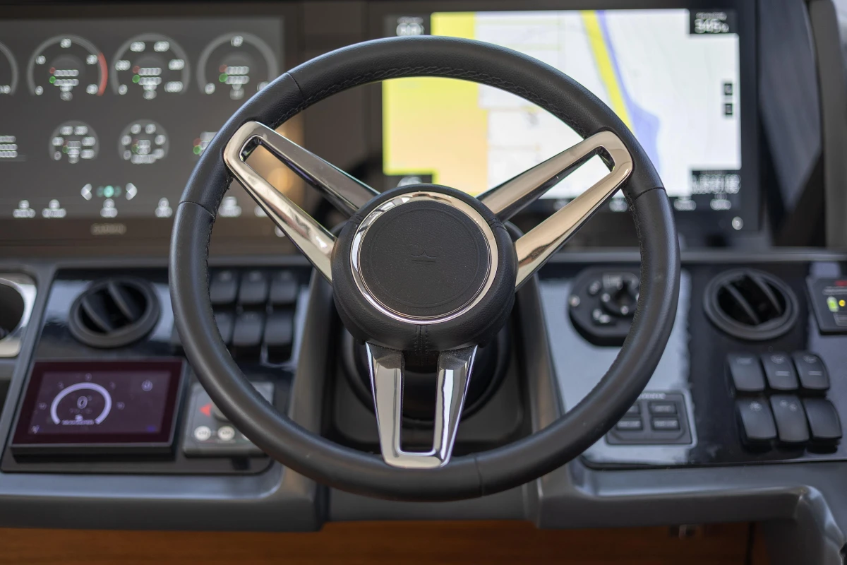 Steering wheel and dashboard of 2019 Princess F50 yacht with navigation display.