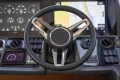 Steering wheel and dashboard of 2019 Princess F50 yacht with navigation display.
