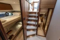 Luxurious interior of 2019 Princess F50 yacht with bunk beds and elegant staircase.