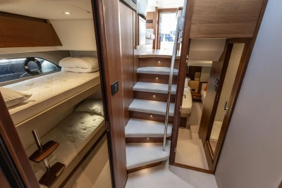 Luxurious interior of 2019 Princess F50 yacht with bunk beds and elegant staircase.