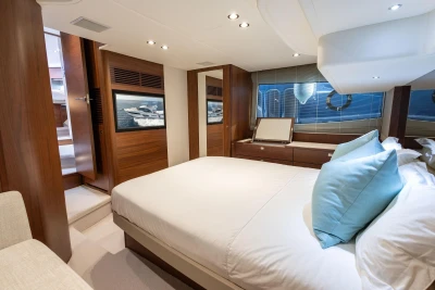 Luxurious 2019 Princess F50 yacht bedroom with elegant wood finishes and modern decor.
