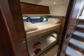 Luxurious 2019 Princess F50 yacht cabin with cozy bunk beds and elegant wood finishes.