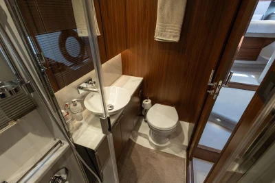 Luxurious 2019 Princess F50 yacht bathroom with modern fixtures and elegant wood paneling.