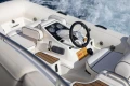 Cockpit of 2019 Princess F50 yacht with steering wheel and control panel.